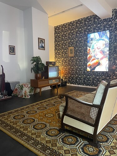 A living room with a digital screen displayed like a picture on a wall
